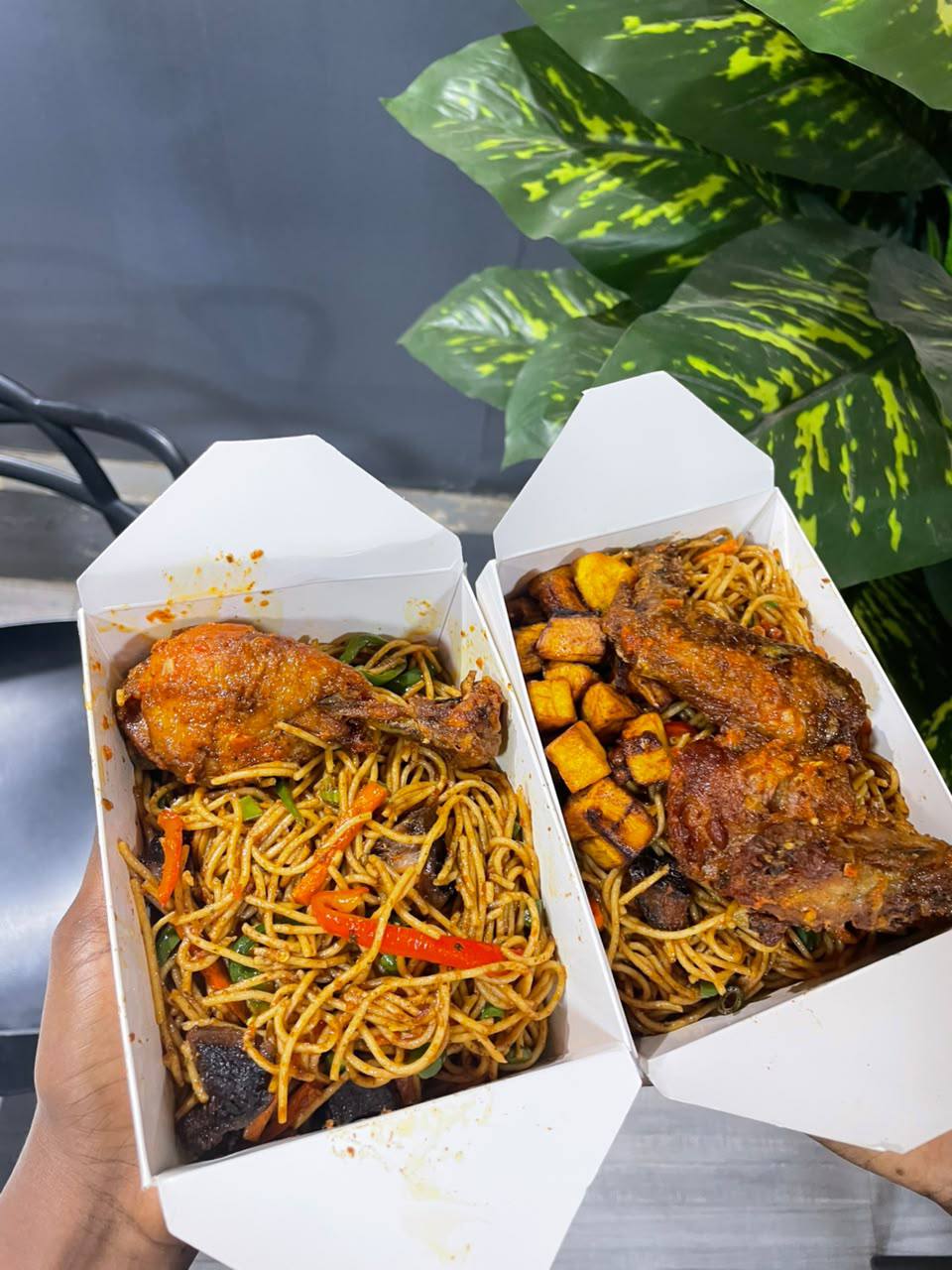 Orchid noodles and chicken in takeaway boxes